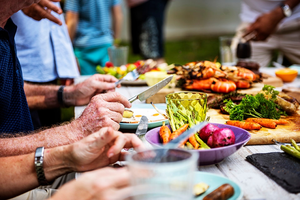 Menschen, die gemeinsam am Tisch sitzen und essen.