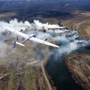 The smoke from the burning of dry grass (drone image).Local residents set fire to the grass specifically. Small animals are bending. Local features and habits. Near Kiev,Ukraine