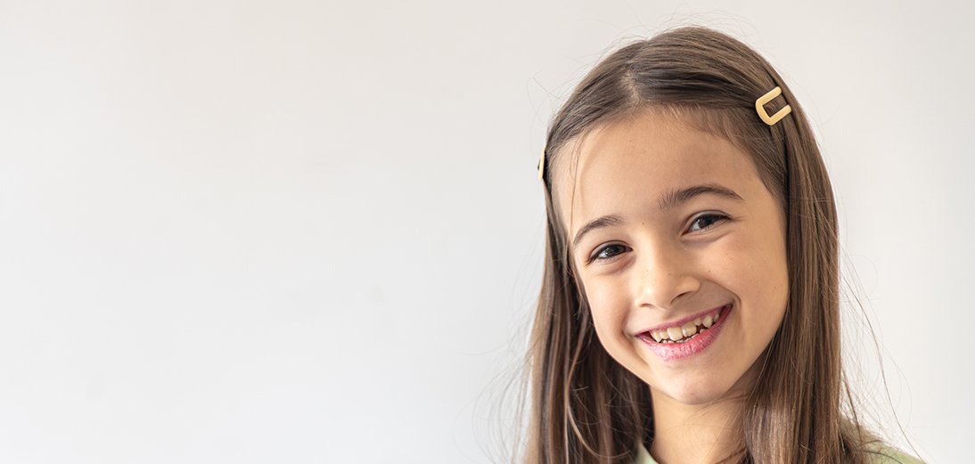 The girl packs a backpack for school. Schoolgirl with a backpack.